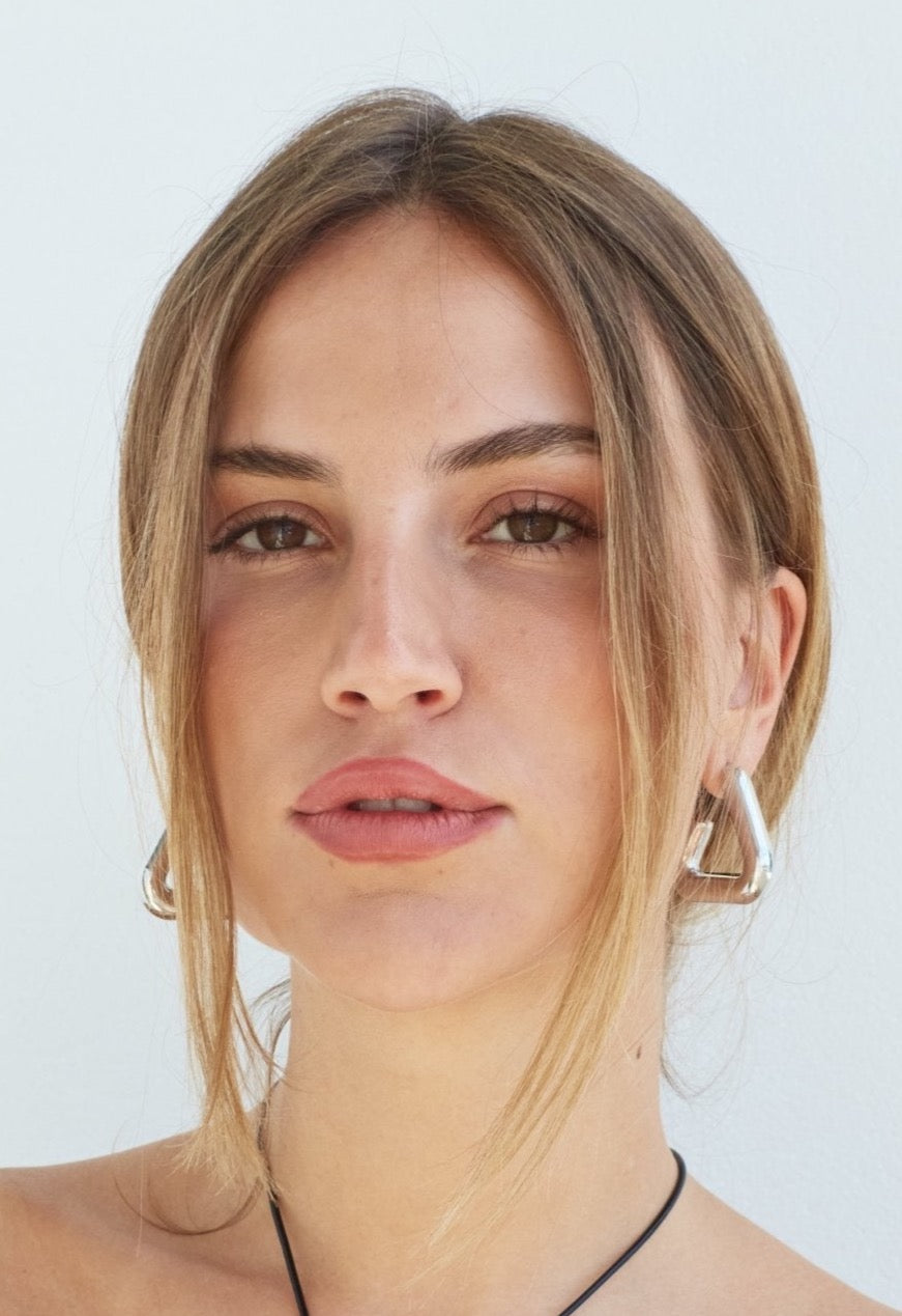 Model in Giza triangle shaped earrings 