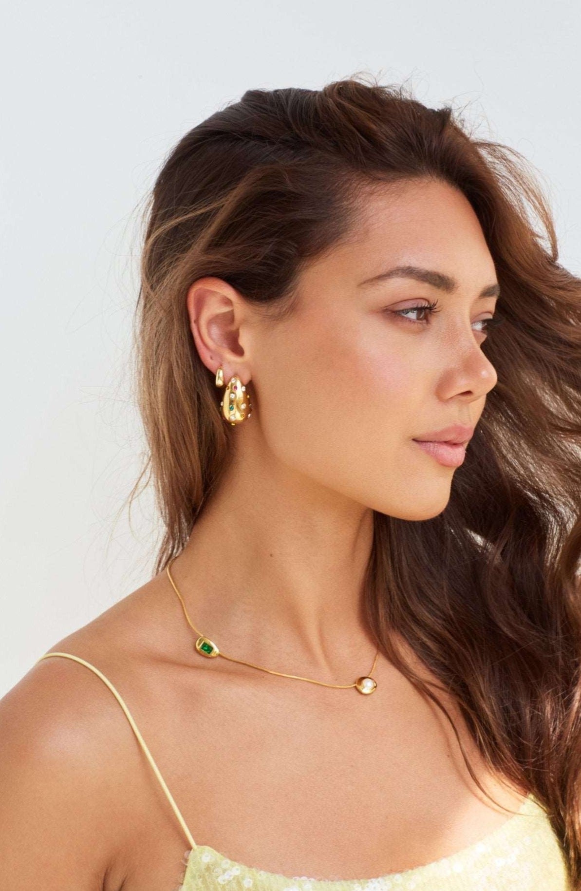 Model wearing Bottega shaped earrings